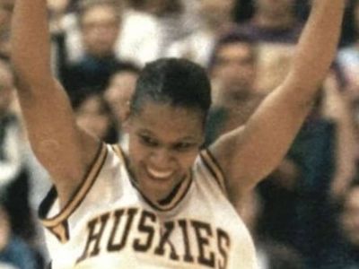 Rhonda Smith Banchero is celebrating while in her Huskies jersey.